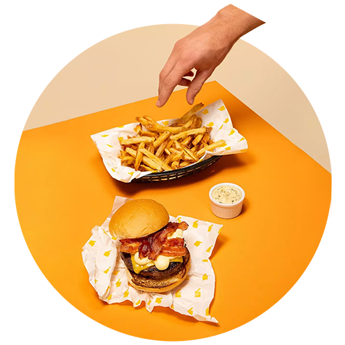 Hand reaching for a burger